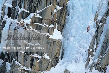 High angle view of a person climbing a snow covered mountain