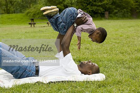 Portrait of a father lifting his son