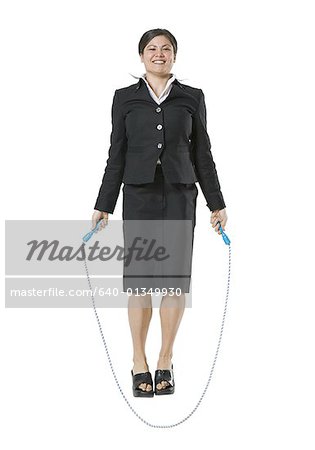 Portrait of a businesswoman jumping rope