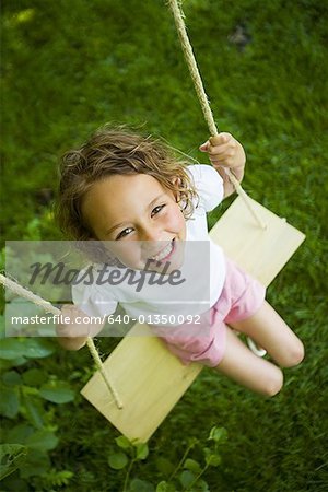 High angle view of a girl sitting on a swing