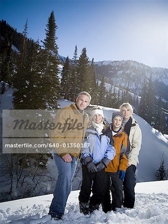 Portrait of parents with their children in the snow