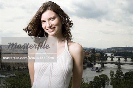 Portrait of a teenage girl smiling in front of landscape