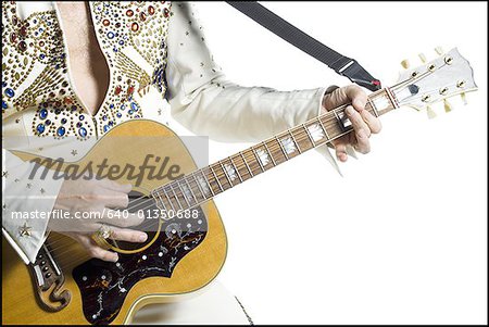 Close-up of an Elvis impersonator playing the guitar