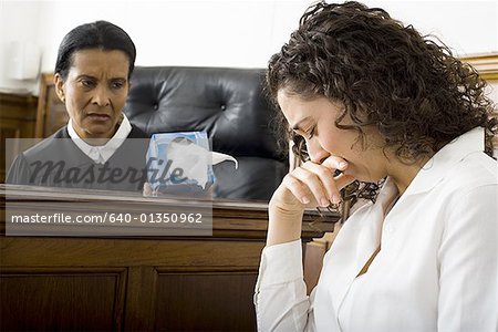 Female judge offering tissue to a female witness