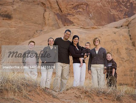 Family standing in front of rock formation