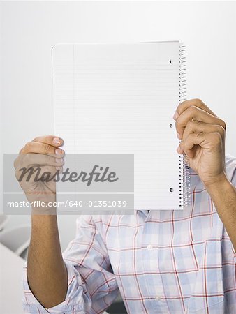 African American male student holding blank workbook