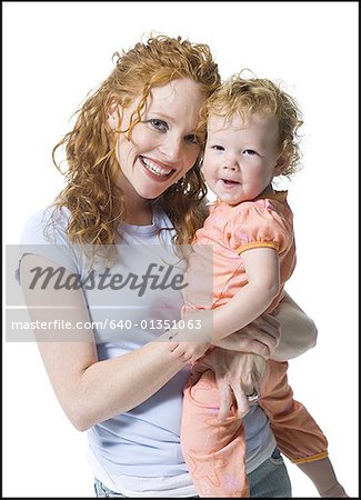 Portrait of a young woman hugging her daughter