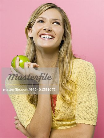 Woman smiling with green apple