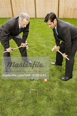 High angle view of two businessmen playing croquet