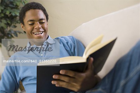 Teenage boy reading a book