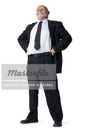 Businessman standing with arms akimbo