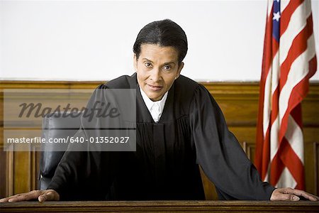 Portrait of a female judge leaning against a bench