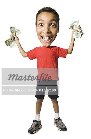 Boy holding fistfuls of US dollar bills