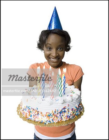 Portrait of a young woman holding a birthday cake