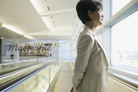 Side profile of a businesswoman standing at a subway station