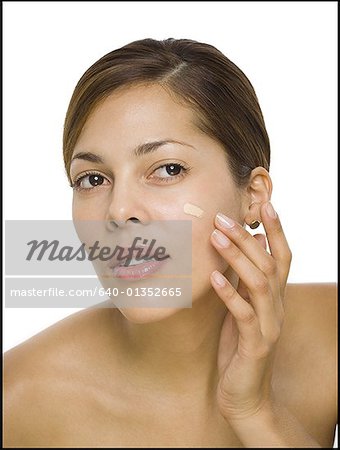 Close-up of a woman applying moisturizer on her face