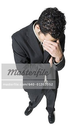 High angle view of a businessman looking depressed