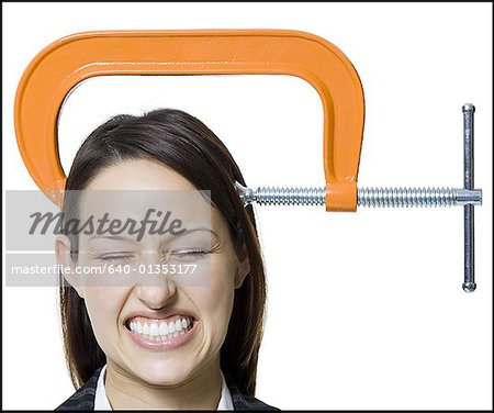 Close-up of a businesswoman with a clamp on her head