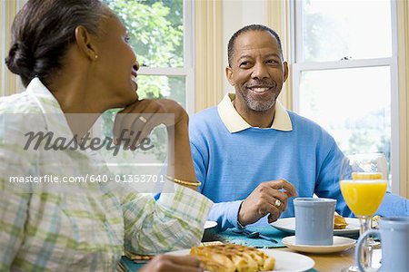 Senior man and a senior woman sitting at the breakfast table