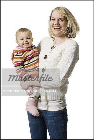 Woman laughing and holding baby girl