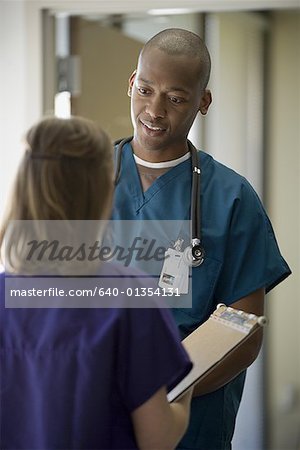 Male doctor talking to a female doctor
