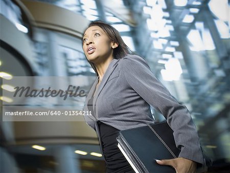 Close-up of a businesswoman carrying files