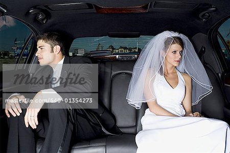 Close-up of a newlywed couple sitting in a car