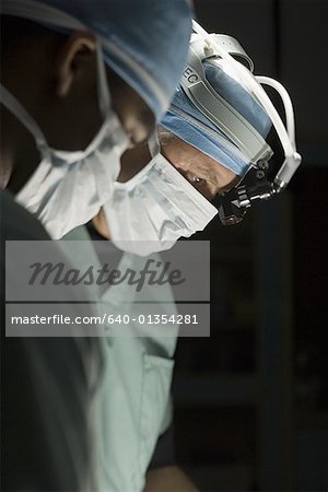 Close-up of two surgeons operating