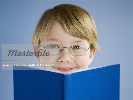 Boy reading book and smiling