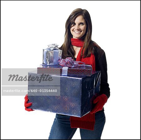 Woman with Christmas gifts smiling