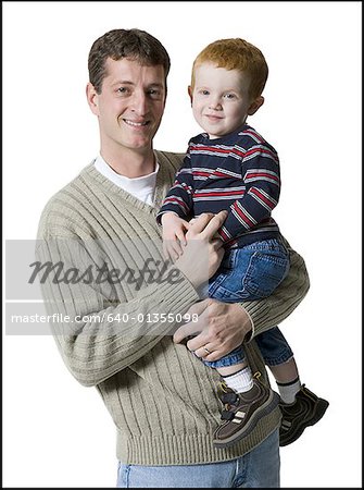 Portrait of a father carrying his son