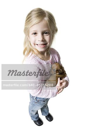 High angle view of a girl holding a dachshund