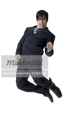 Businessman jumping in mid-air