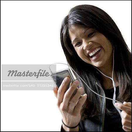 Close-up of a young woman listening to an MP3 player