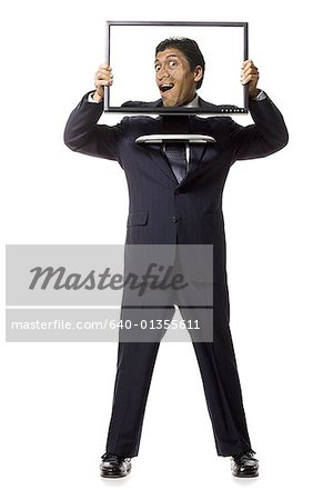 Businessman with funny face on monitor