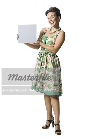 Woman in floral dress holding a blank sign