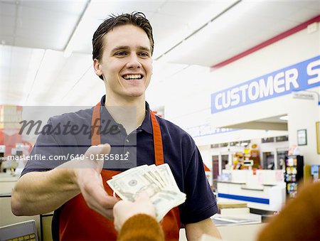 Cashier taking money from customer