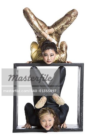 Female contortionist duo with box prop