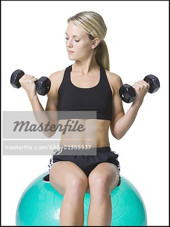 Young woman exercising with dumbbells