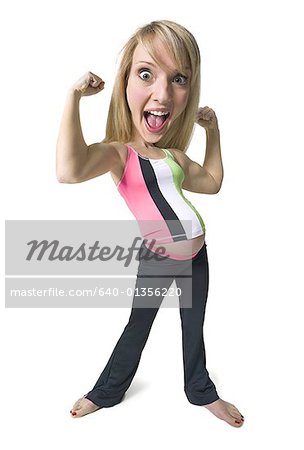 Pregnant young woman flexing her muscles