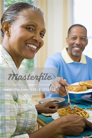 Portrait of a senior man and a senior woman having breakfast