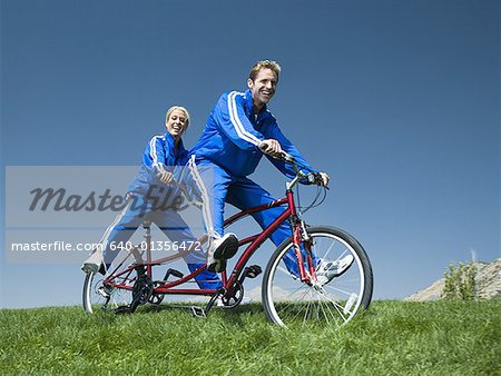 Couple riding on a tandem bicycle