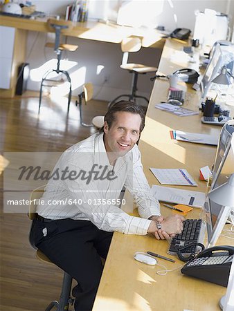 High angle view of a businessman sitting in front of a computer