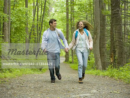 Young couple running and holding hands