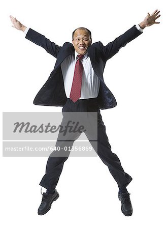 Portrait of a businessman jumping with his arms outstretched