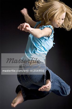 Side profile of a young woman jumping