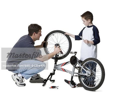 Father and son repairing a bicycle