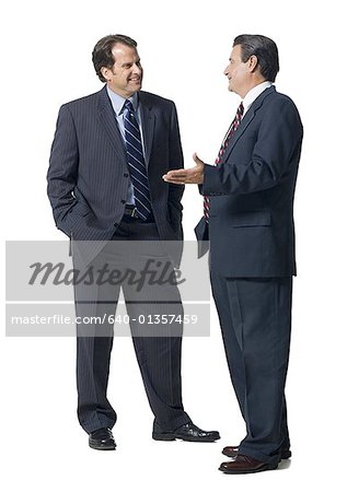 Two businessmen talking and smiling