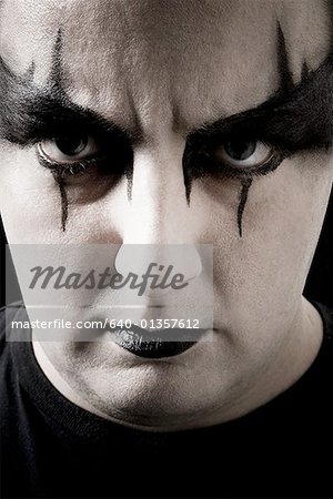 Close-up of man with black and white makeup