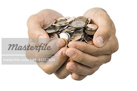 Close-up of hands full of coins